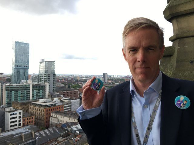Manchester Health and Care Commissioning chief accountable officer Ian Williamson with the new badge.