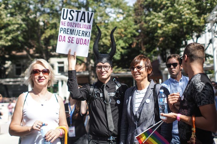 <p>“The Constitution forbids the Prime Minister to get married” - activist Predrag Azdejkovic holding a banner as a reality check. On the left, Helena Vukovic, a transgender former Serbian Army officer</p>