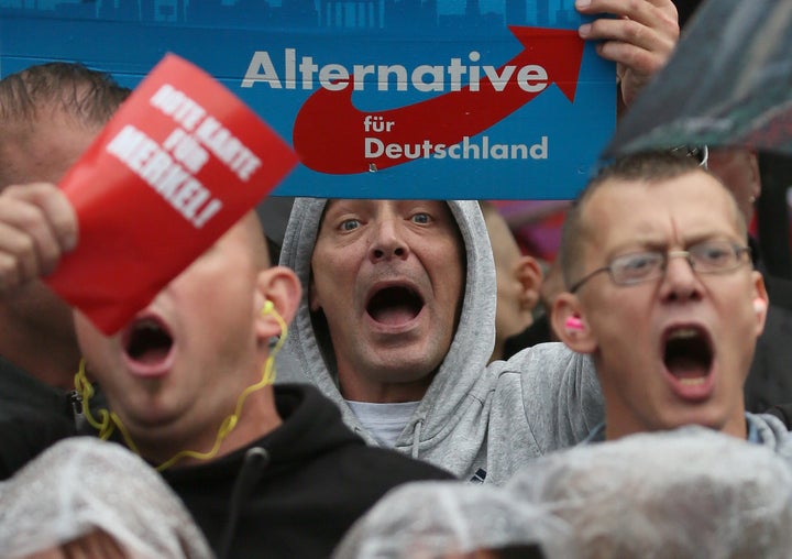 Supporters of the hard-right Alternative for Germany (AfD) party shout slogans during an election campaign rally of German Chancellor Angela Merkel.