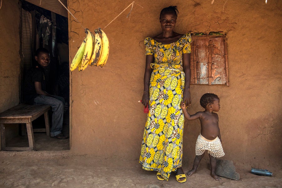 Uma residents stand outside a small clinic in the village.