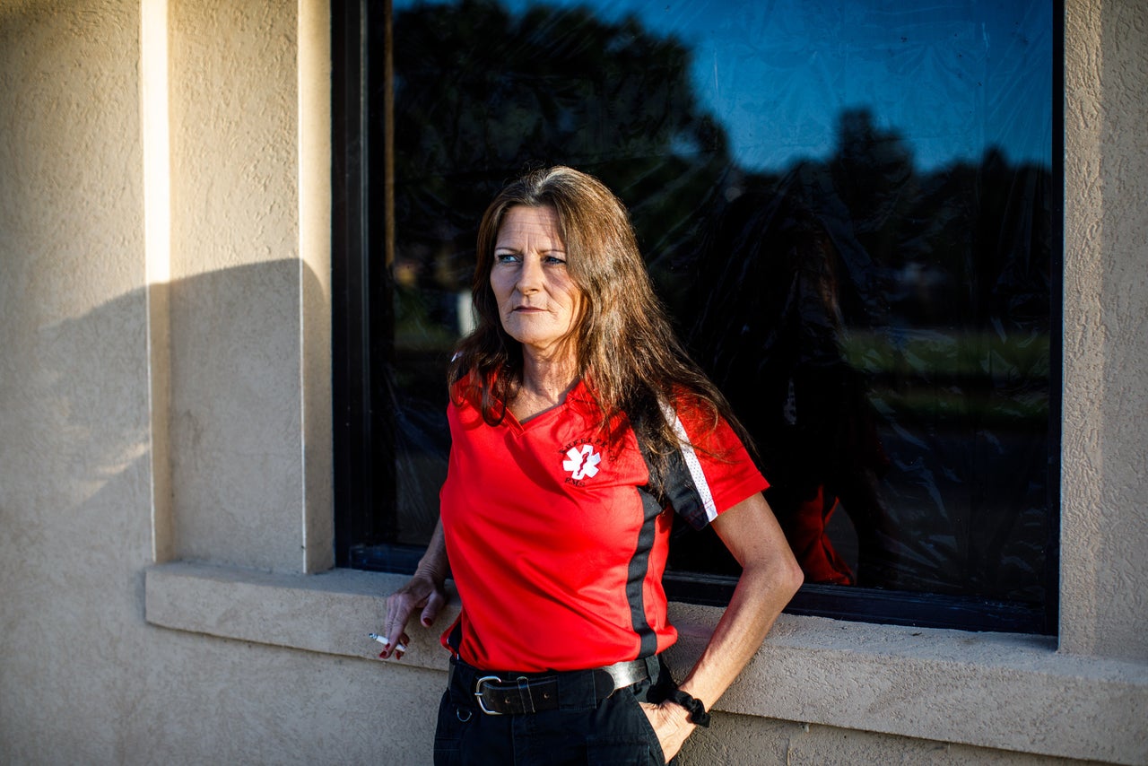 Selena Howell, the director of EMS for Wheeler County, smokes a cigarette outside the Glenwood City Hall and Fire Station.