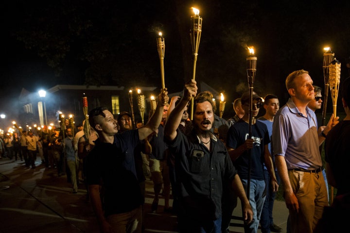 Neo-Nazis and white supremacists march through the University of Virginia campus in Charlottesville, Virginia on Aug. 11.