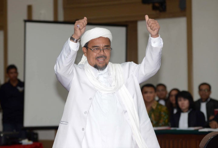 Rizieq Shihab, the head of Islamic Defenders Front, arrives in court to testify in Purnama's blasphemy trial. Feb. 28.