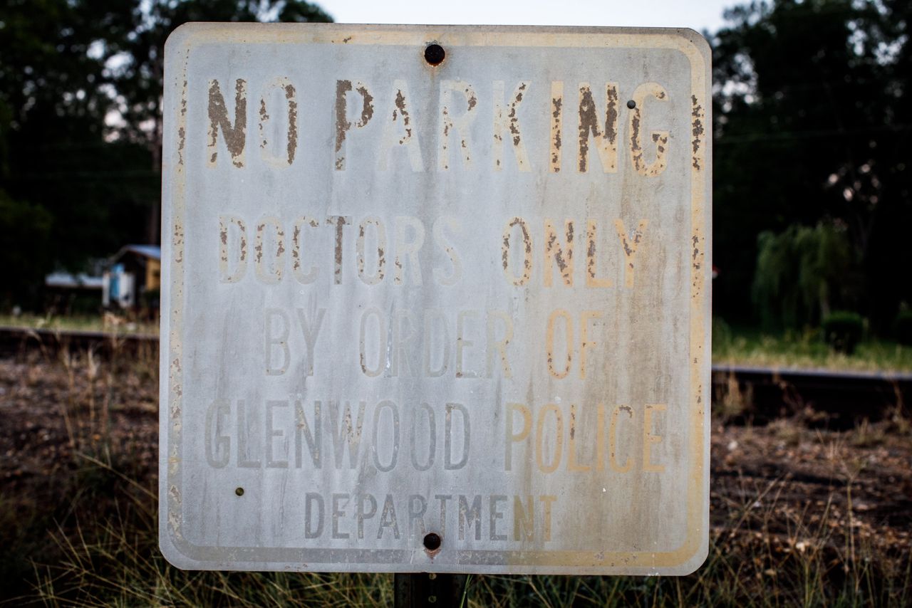 Weathered parking signs posted outside the shuttered Lower Oconee Community Hospital in Glenwood.