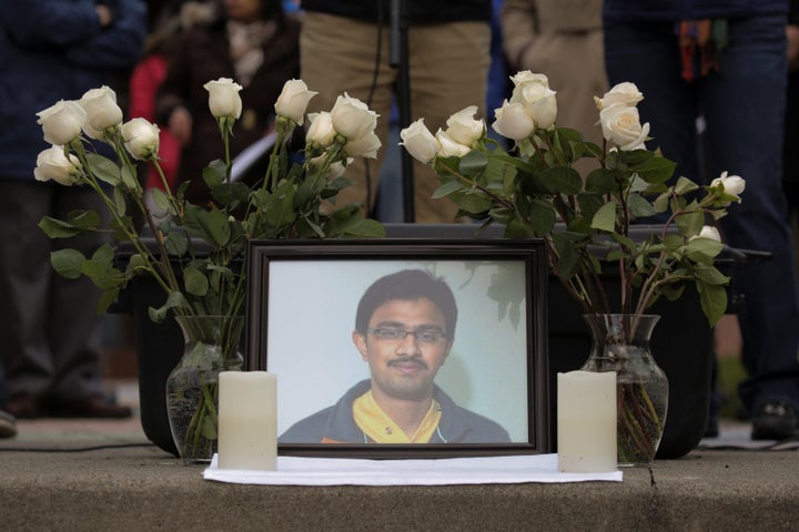 A picture of Srinivas Kuchibhotla, an immigrant from India who was recently shot and killed in Kansas, is surrounded by roses