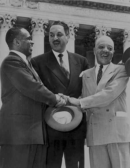 <p>James Nabrit ‘23 (right), Thurgood Marshall (center), and George E.C. Hayes (left) congratulate each other for winning the landmark <em>Brown v. Board</em> case against segregation in 1954.</p>