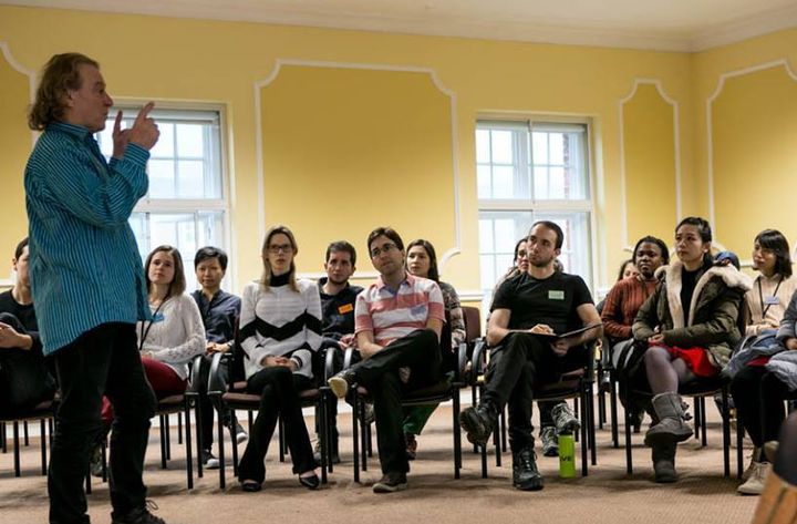 A music teacher talking to a gathering of Cumberland, Cambridge Trust and Chevening Scholars