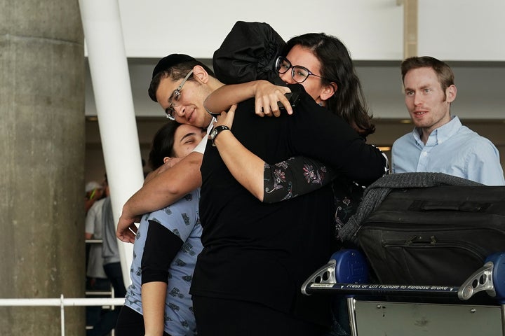 People hug after arriving in advance of the travel ban to the U.S. at John F. Kennedy airport in New York City, on June 29.