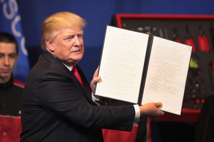 President Donald Trump signs an executive order to try to bring jobs back to American workers and revamp the H-1B visa guest