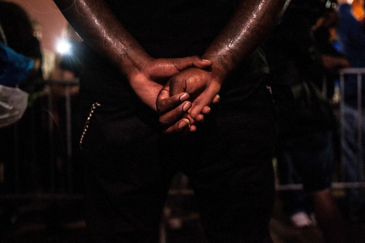 A protester stands outside the Justice Center in St. Louis on Monday evening.