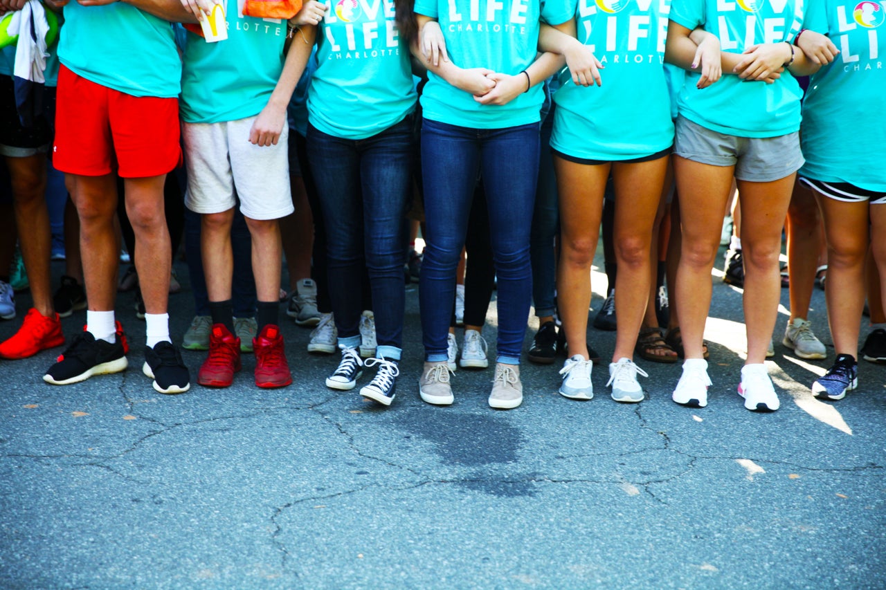 Kids link arms outside A Preferred Women's Health Center in Charlotte to protest abortion access.