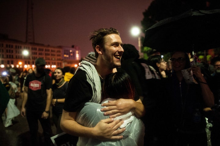 Mike Price, a 24-year-old arrested Sunday, hugs a friend as he walks out of the St. Louis City Justice Center after his release Monday.