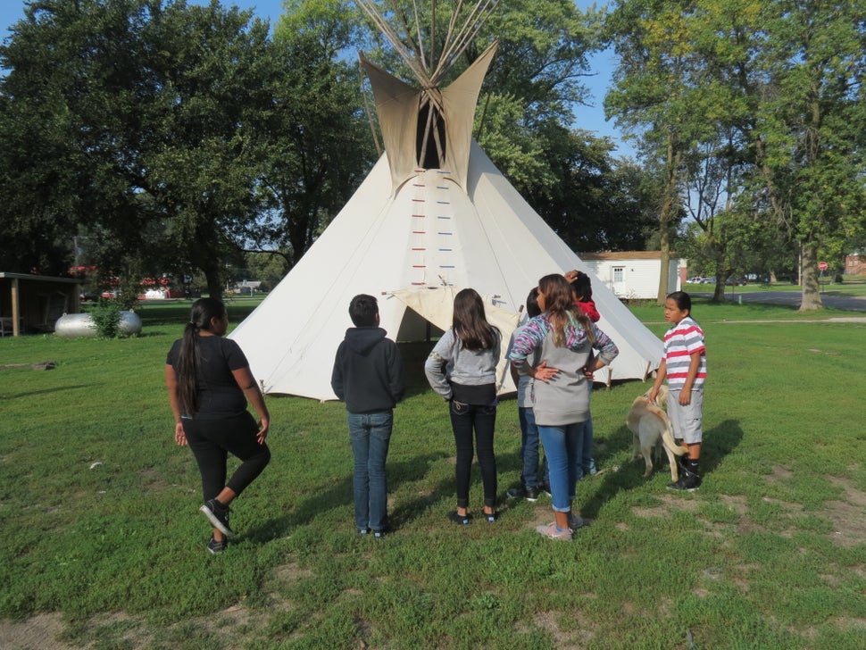 A middle school class from Umonhon Nation Public School, out on a cultural experience in the community, learning about the ti