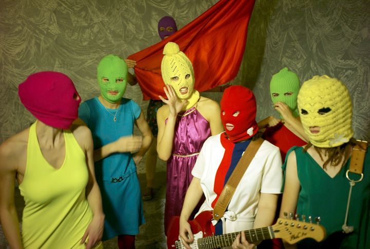 The feminist punk rock group Pussy Riot in their signature colorful balaclavas.