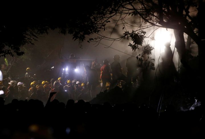 Rescuers had to work by torch light after power was cut in many areas of Mexico 