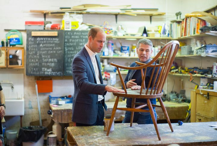 The Duke of Cambridge speaks with volunteer and former client Bernard Bristow during his visit to the trust in St Leonard's Church in Shoreditch
