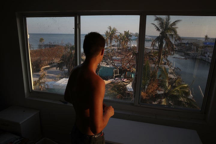 Markus Reinfandt looks out the window of his home onto the mobile homes that were destroyed by Hurricane Irma on Sept.18, 2017, in Marathon, Florida. 