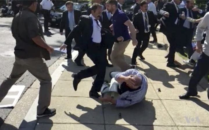 Members of Turkish President Recep Tayyip Erdogans security detail are shown violently reacting to protesters during his trip