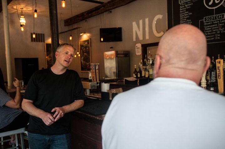 Chris Sommers, owner of Pi Pizzeria, talks to supportive customers in his Central West End location in St. Louis on Wednesday.
