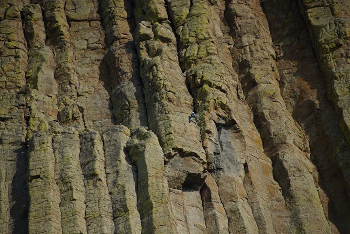 <p>The columnar lava forming the Tower is called Phonolite Porphyry which is a relatively rare type of lava. Note the CLIMBER just right of center. NOW the scale of the Tower can be fully appreciated!</p>