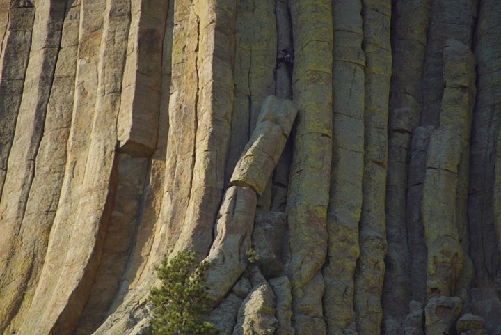 <p>One of the columns that weighs several tons has broken off in this photo and is resting against the body of the Tower. Note the climber ABOVE it straddling the single column. </p>
