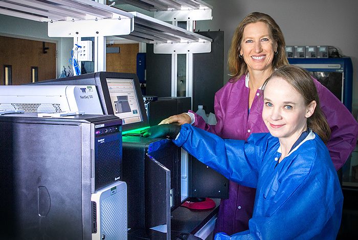 Scientists at Los Alamos National Laboratory are improving the identification of the bacterium that causes tularemia (“rabbit fever”) and considered a “Category A” bioterrorism agent by the Centers for Disease Control and Prevention. At left, principal investigator Jean Challacombe, assisted by Cheryl Gleasner who runs the sequencing machines, and who participated in the sequencing of most, if not all, of the Francisella genomes sequenced at Los Alamos. The device shown is an Illumina NextSeq 500, used in high-throughput sequencing in the laboratory.