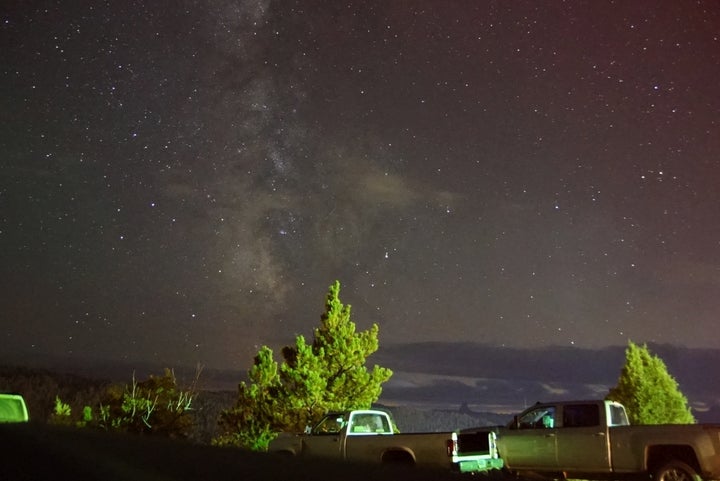 Milky Way with some cloudy interlopers inHulett. Note that Devil’s Tower, 9 miles away is visible in the distance just above the front of the hood on the right hand truck. 