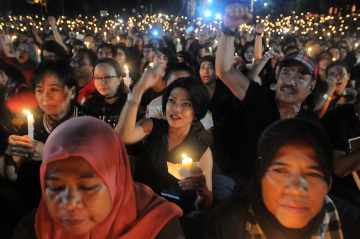 Supporters of ethnic Chinese Christian Jakarta governor, Basuki Tjahaja Purnama, gather after he's charged with blasphemy.