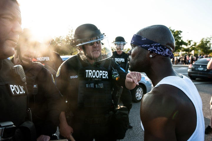 Riot police keep protesters from marching down Brentwood Boulevard in Clayton, Missouri, on Wednesday.