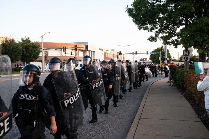 Riot police fall back and get on buses to leave once the protesters had dispersed.