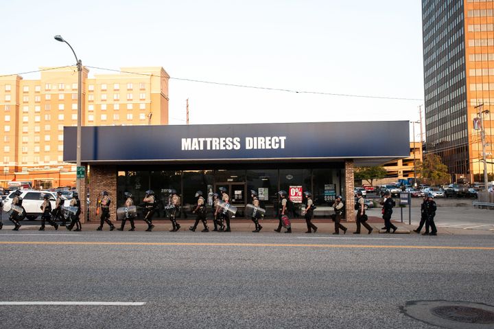 Riot police leave the scene of the protest in Clayton, a St. Louis suburb.