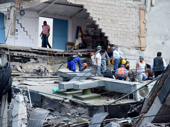 People look for possible victims after walls collapsed during the earthquake in Mexico City