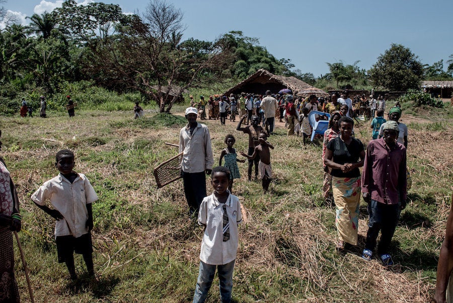 Residents of Uma leave a community center following a meeting with traveling doctors.