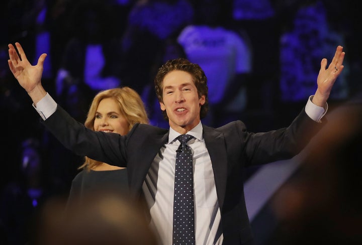 Joel Osteen, the pastor of Lakewood Church, stands with his wife, Victoria Osteen, as he conducts a service on Sept. 3. He was criticized for not initially opening his giant church as a shelter for Hurricane Harvey evacuees.