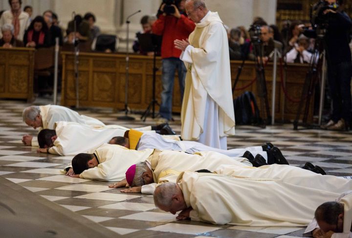 A picture taken on Nov. 23, 2014, shows archbishop of Granada Francisco Javier Martinez (third right) prostrating himself on the floor with other priests at the city's cathedral during a Mass in a gesture of apology to victims of abuse.