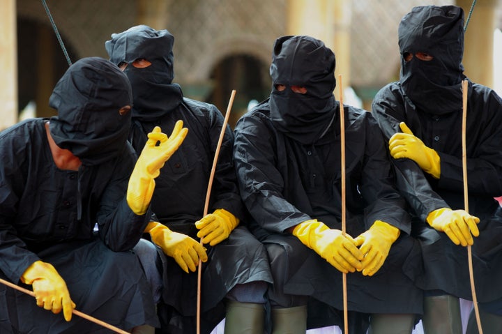 Members of Aceh's so-called Sharia police during a public caning in Meulaboh on Feb. 12, 2016. Aceh is the only province in Indonesia that is allowed to implement Islamic Sharia law.