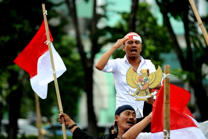 Indonesian demonstrators call for the police and military to crack down on hard-line Islamist groups like Islamic Defenders Front on Jan. 26, in Surabaya, Indonesia.