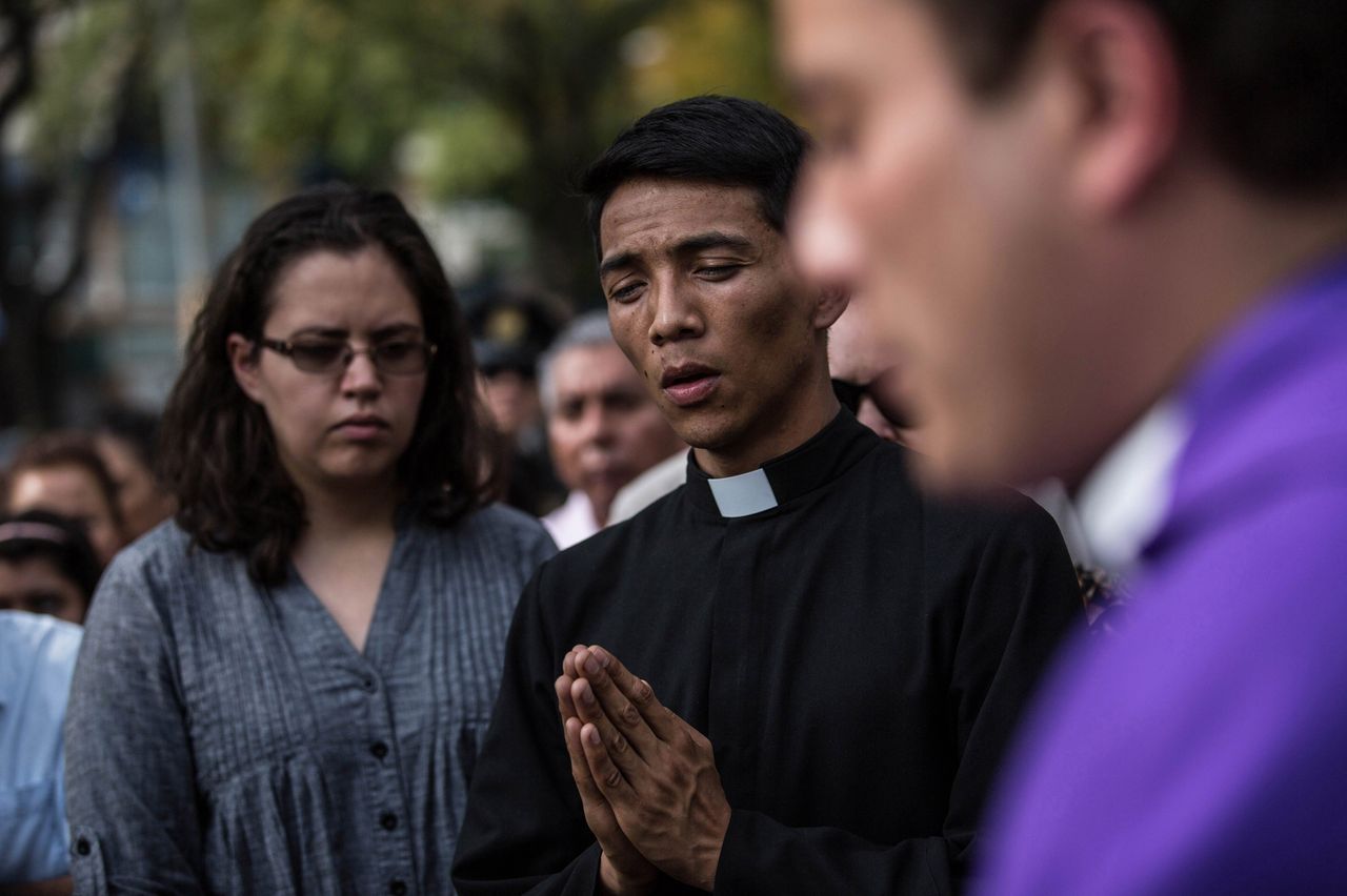 Relatives and friends of victims attend a catholic mass outside the the Enrique Rebsamen school that collapsed during Tuesday's magnitude 7.1 earthquake in Mexico City, Mexico. 