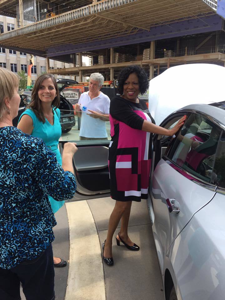 <em>Ann Vail, Executive Director of Louisiana Clean Fuels and Mayor Broome speak for an EV owner at an electric vehicle at t