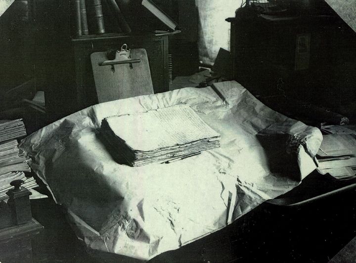 The printer’s manuscript of the Book of Mormon rests on a table in this early 20th-century photograph. 