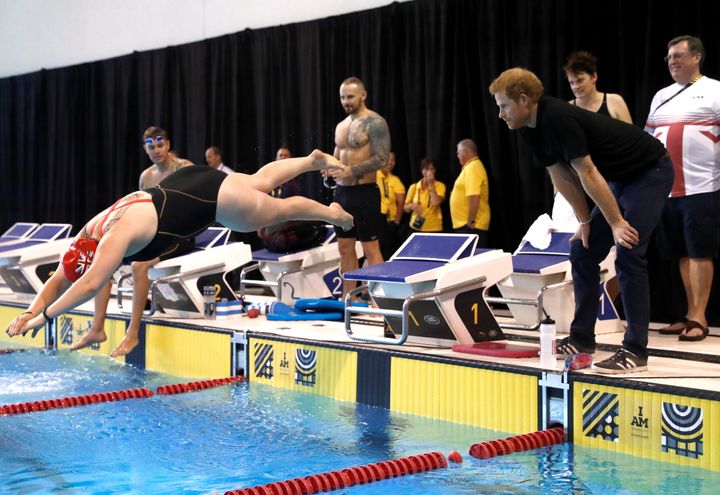 Prince Harry watches swimmers preparing for the Invictus Games.