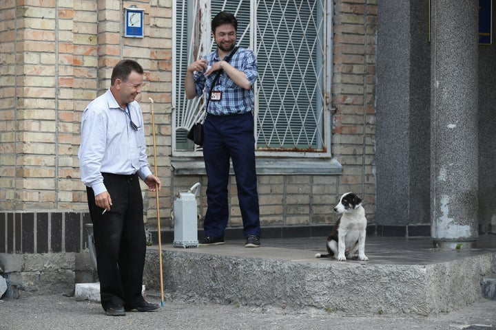 Workers with a stray dog at the Chernobyl nuclear power plant in August 2017.