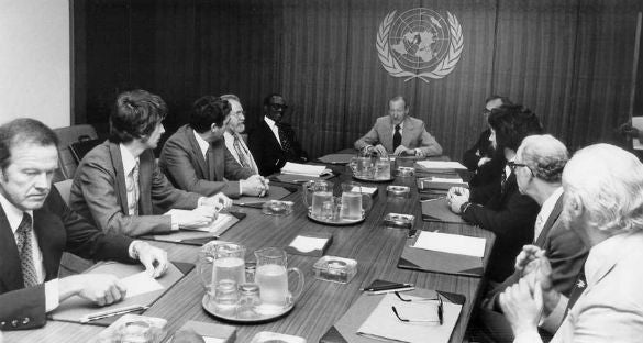 <p>Meeting at the UN on UFOs. Clockwise from left: astronaut Gordon Cooper, astronomer Jacques Vallee, astronomer/astrophysicist Claude Poher, astronomer J. Allen Hynek, Grenada Prime Minister Sir Eric Gairy, UN Secretary-General Kurt Waldheim, Morton Gleisner of the Special Political Committee, Lee Speigel, researcher Len Stringfield, and University of Colorado psychologist David Saunders.</p>