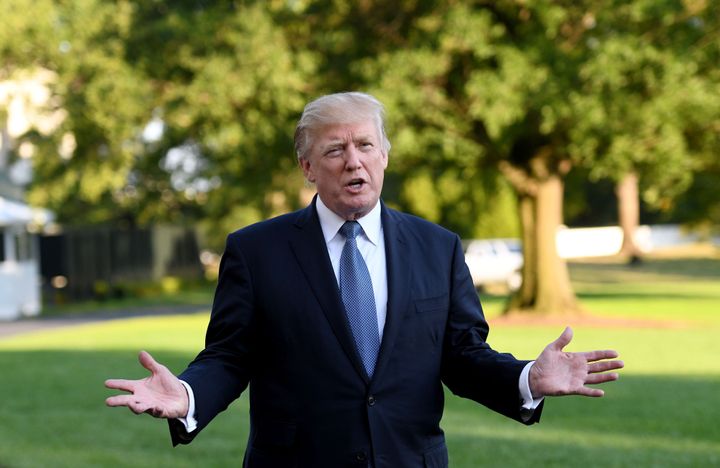 U.S. President Donald Trump answers questions from the press after stepping off Marine One on the South Lawn.