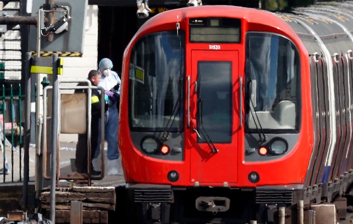 Police forensics workers at the scene following the incident at Parsons Green on 15 September 