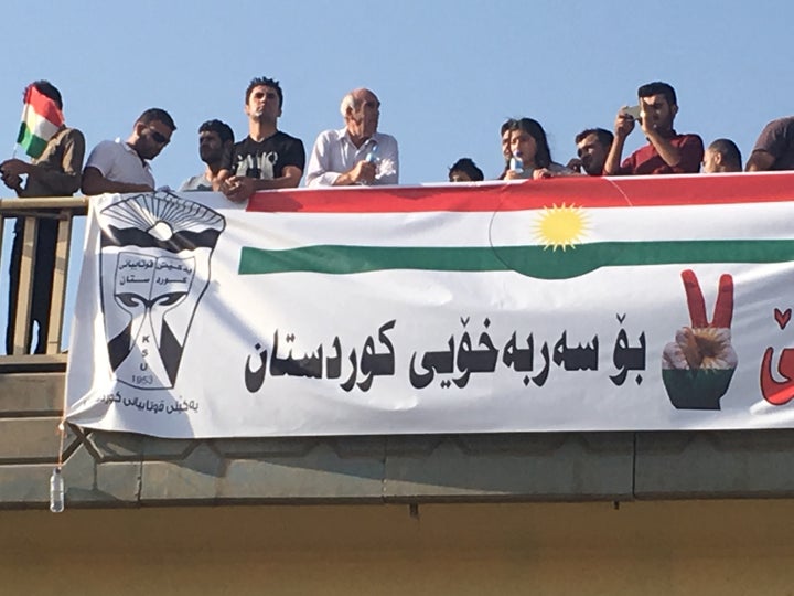 Kurdish independence supporters look on from overpass, Erbil, Iraq, Sept. 22, 2017.