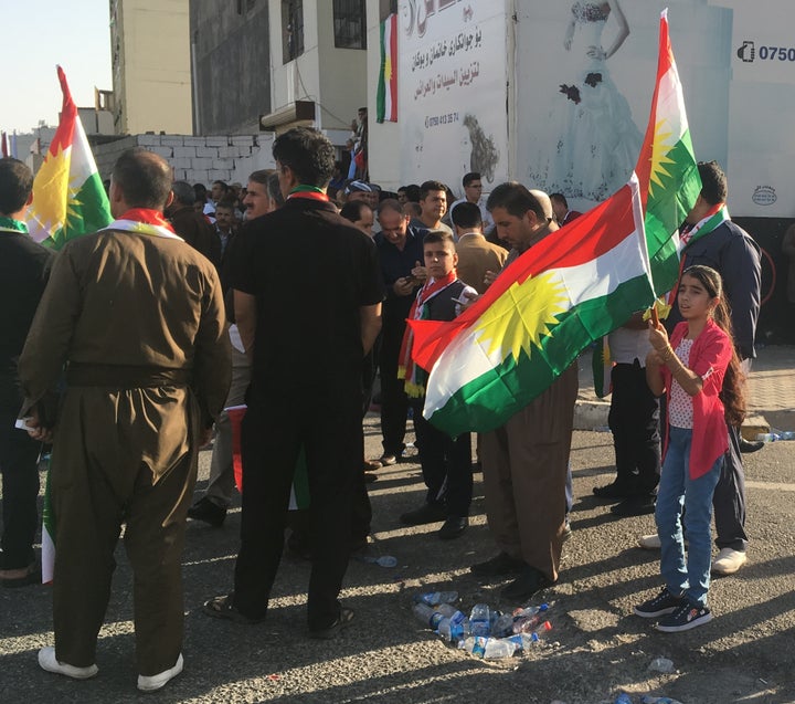  Kurds look on at rally for independence, Erbil, Iraq, Sept. 22, 2017.