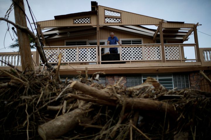 A man looks at the damages to his house after the area was hit by Hurricane Maria in Toa Baja, Puerto Rico.
