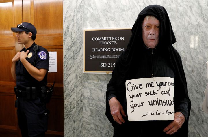 A protester dressed as the grim reaper stands outside the Senate Finance Committee hearing room Monday hours ahead a hearing on the latest effort to repeal Obamacare on Capitol Hill in Washington.