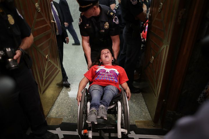 U.S. Capitol Police arrest activists from handicap advocacy organizations as protest during a Senate Finance Committee hearing about the proposed Graham-Cassidy Healthcare Bill in the Dirksen Senate Office Building on Capitol Hill September 25, 2017 in Washington, DC.